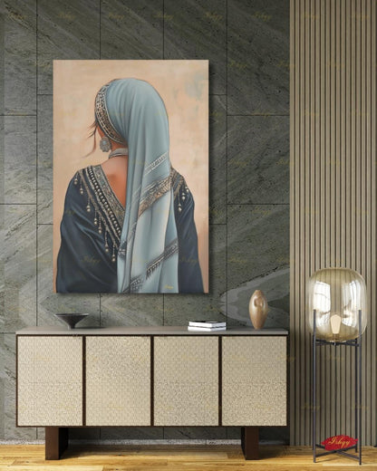 Berber Woman Wall Art, North African Portrait Print, Moroccan Tribal Canvas, Amazigh Culture Decor, Elegant Framed Canvas, Morocco Art Gift. Back-view portrait of a woman in a pale blue veil with an ornate silver headband, wearing a navy embroidered garment with silver beading and dangling ornaments, a floral silver earring, and a pearl necklace, against a warm beige textured background.