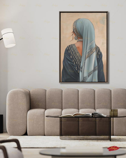 Berber Woman Wall Art, North African Portrait Print, Moroccan Tribal Canvas, Amazigh Culture Decor, Elegant Framed Canvas, Morocco Art Gift. Back-view portrait of a woman in a pale blue veil with an ornate silver headband, wearing a navy embroidered garment with silver beading and dangling ornaments, a floral silver earring, and a pearl necklace, against a warm beige textured background.